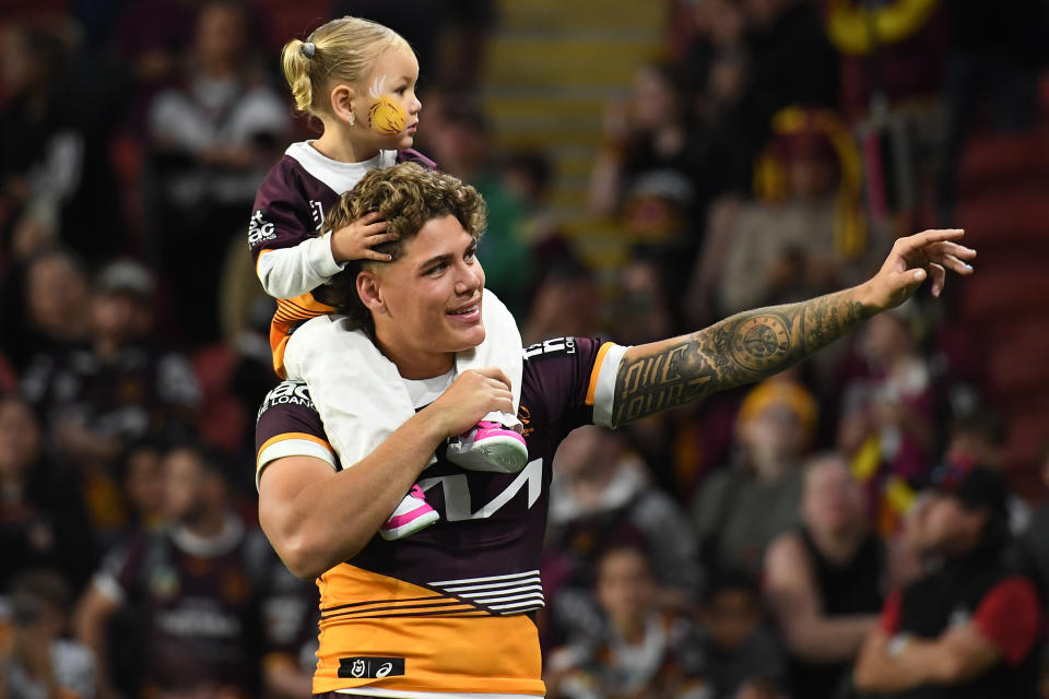 Reece Walsh with daughter Leila after a Broncos game.