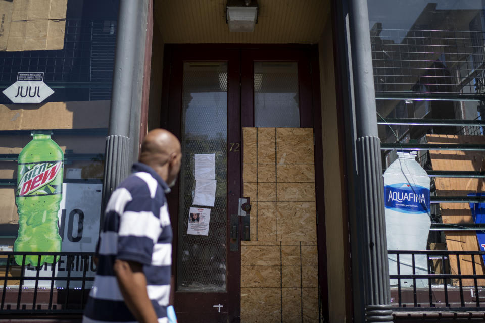 A convenience store is boarded up after the city shut it down in the wake of recent shootings outside the shop in Rochester, N.Y., Tuesday, Aug. 22, 2023. (AP Photo/David Goldman)