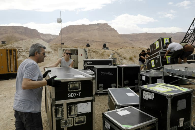 Workers prepare a stage at the foot of the ancient clifftop fortress of Masada on April 2, 2017, ahead of French electronic music pioneer Jean-Michel Jarre's concert there in defiance of US President Donald Trump's environmental policies