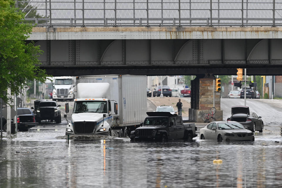 A semi truck maneuvers through a flooded Michigan Avenue at Scotten Street in Detroit, Saturday, June 26, 2021. (Max Ortiz/Detroit News via AP)