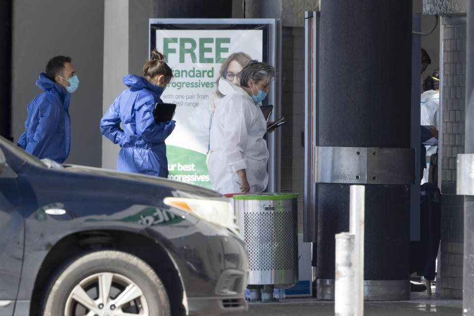 Police forensic staff stand outside a supermarket in Auckland, New Zealand, Saturday, Sept. 4, 2021. New Zealand authorities say they shot and killed a violent extremist, Friday Sept. 3, after he entered a supermarket and stabbed and injured six shoppers. Prime Minister Jacinda Ardern described Friday's incident as a terror attack. (AP Photo/Brett Phibbs)