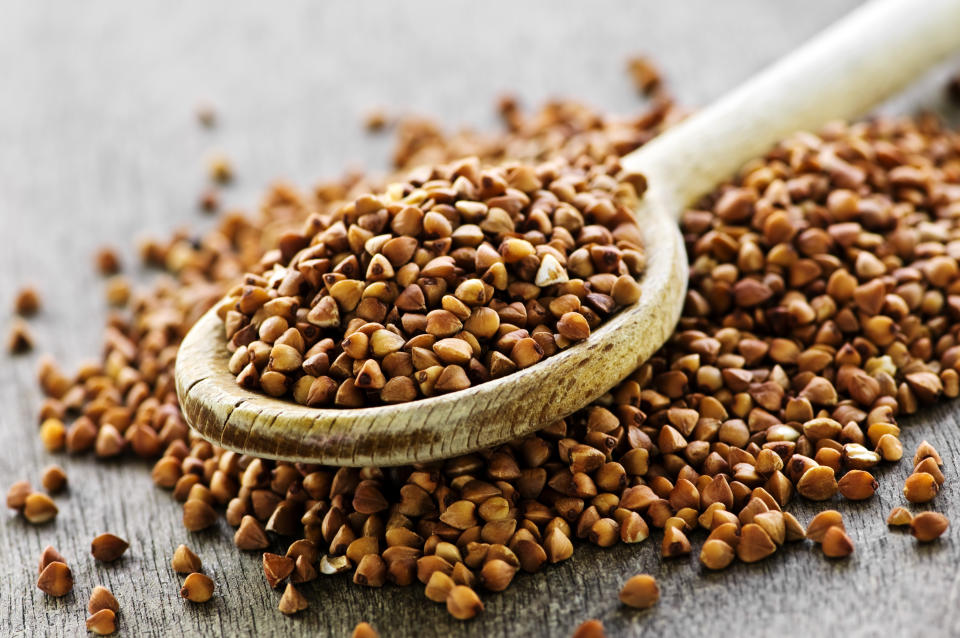 Buckwheat seeds on wooden spoon in closeup