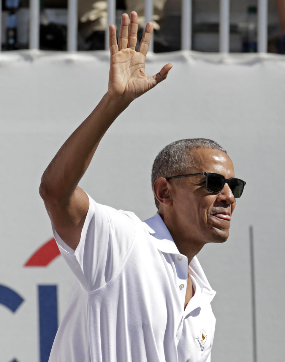 <p>Former President Barack Obama waves to spectators before the first round of the Presidents Cup at Liberty National Golf Club in Jersey City, N.J., Thursday, Sept. 28, 2017. (AP Photo/Julio Cortez) </p>
