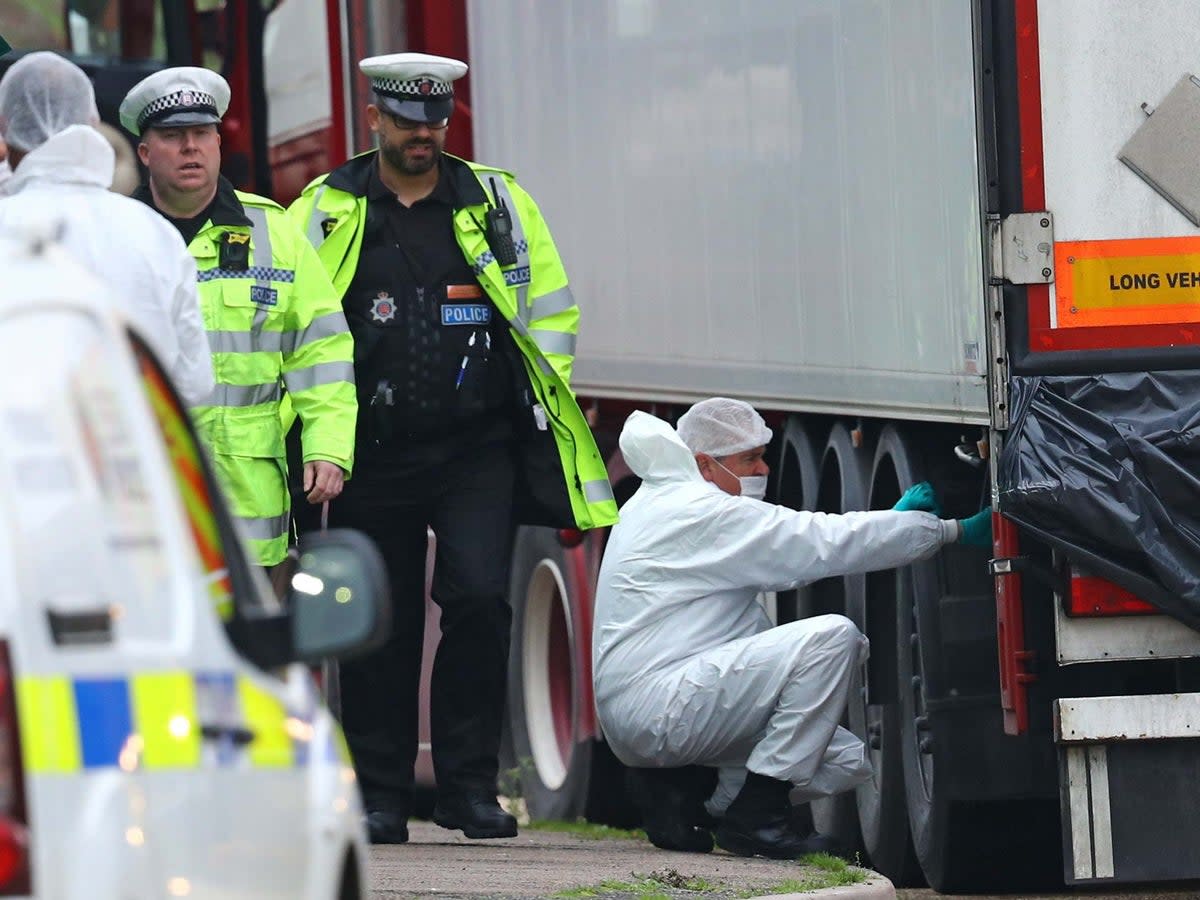 Forensics officers hunt for evidence on the lorry at the industrial park in Grays, Essex (PA)