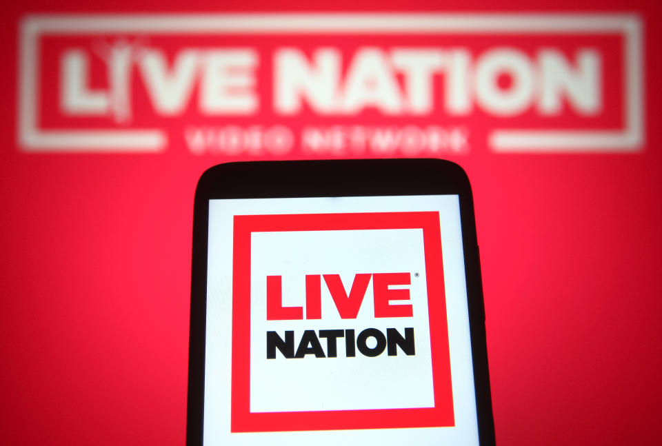 UKRAINE – 2021/07/02: In this photo illustration a Live Nation Entertainment logo is seen on a smartphone and a pc screen.