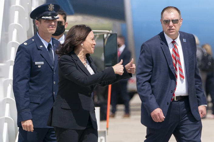 Vice President Kamala Harris, center, makes a double thumbs up sign toward members of the media after exiting Air Force Two after a technical issue required the plane to return to Andrews Air Force Base, Md., Sunday, June 6, 2021, after it had already started begun flying to Guatemala City. (AP Photo/Jacquelyn Martin)