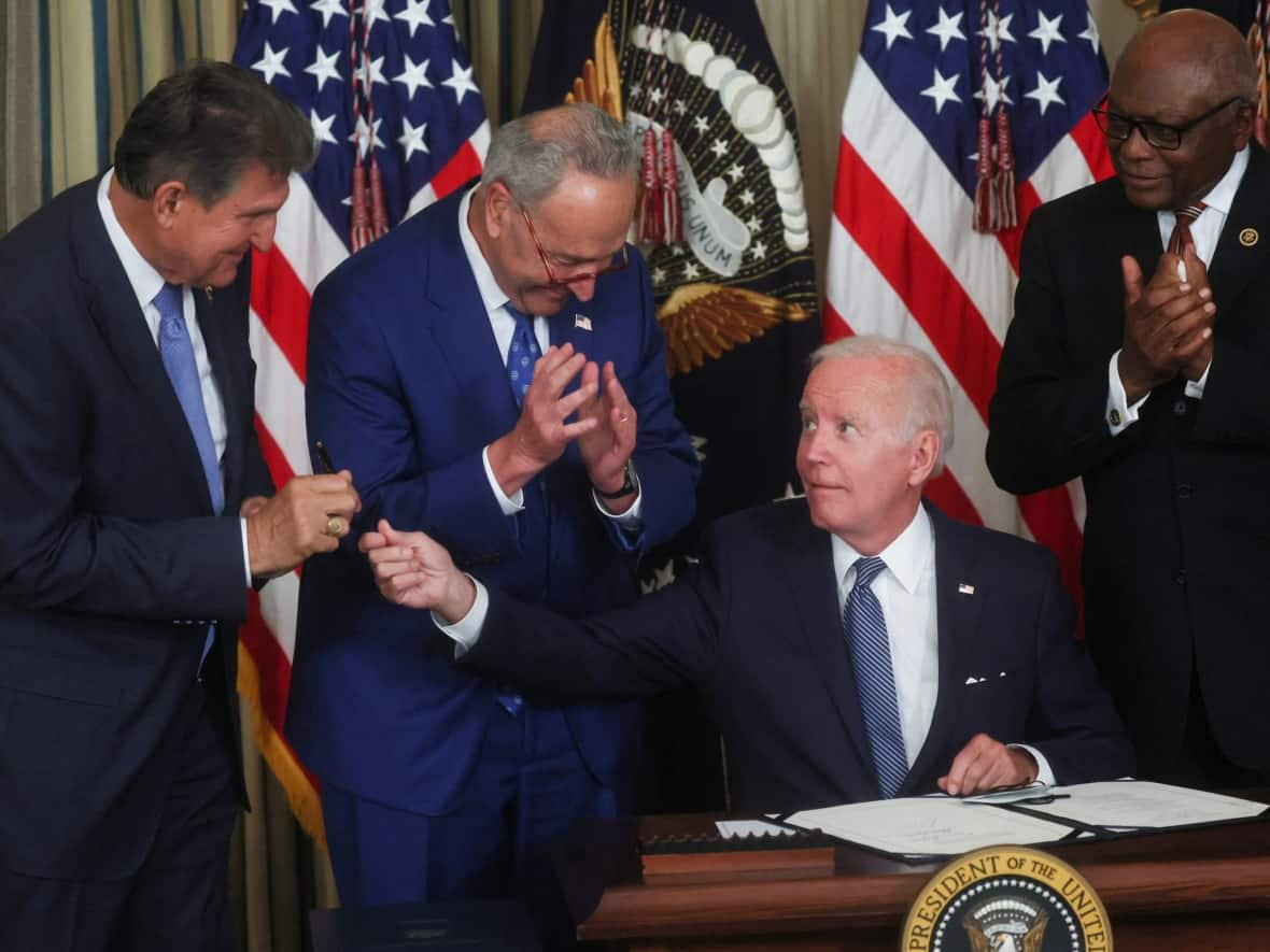 U.S. President Joe Biden signs the Inflation Reduction Act in August 2022. (Leah Millis/Reuters - image credit)