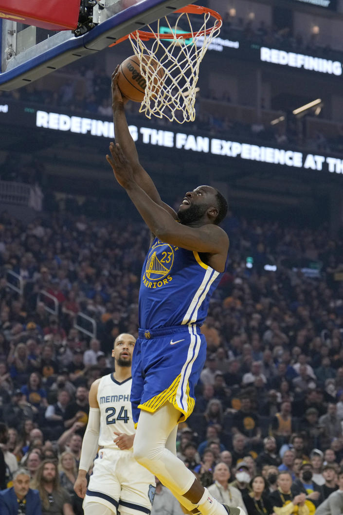 Golden State Warriors forward Draymond Green (23) drives to the basket near Memphis Grizzlies forward Dillon Brooks (24) during the first half of Game 6 of an NBA basketball Western Conference playoff semifinal in San Francisco, Friday, May 13, 2022. (AP Photo/Tony Avelar)
