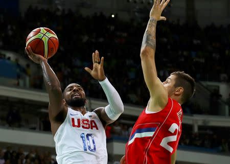 Kyrie Irving shoots over Stefan Jovic of Serbia. REUTERS/Jim Young