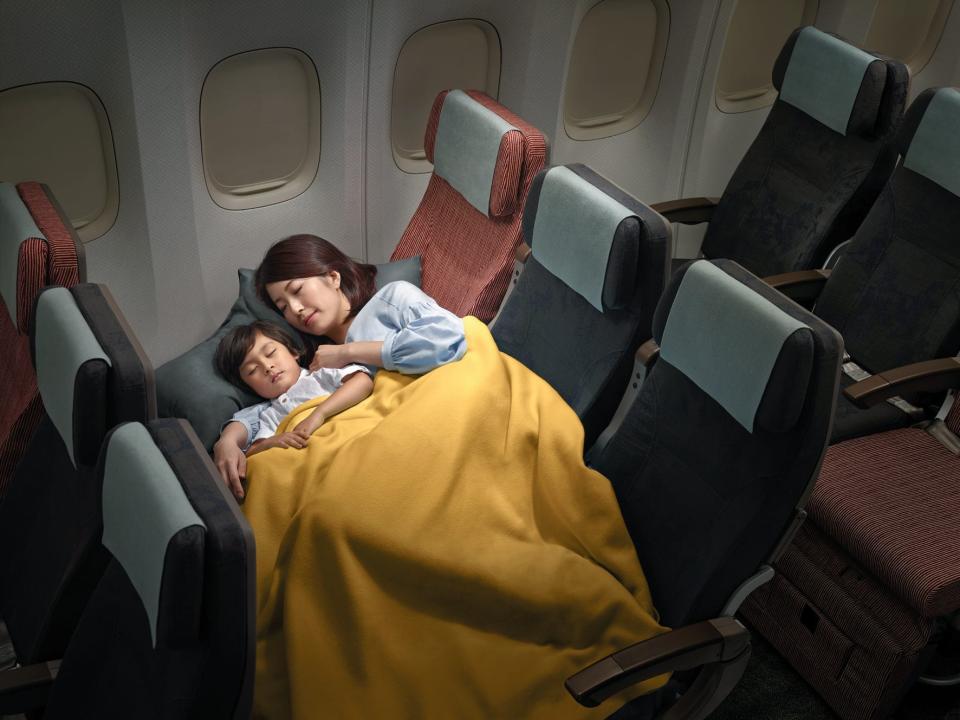 China Airlines Family Couch seating with a mother and child laying on it.