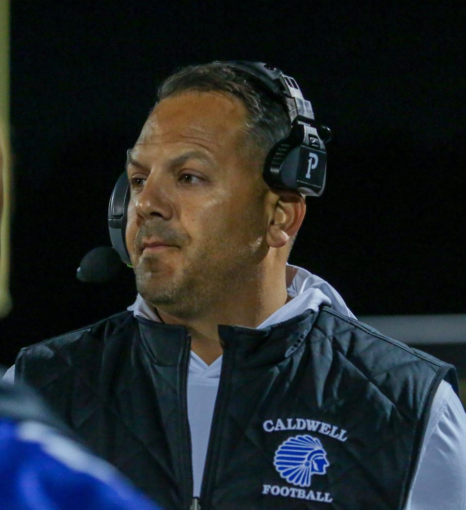 Caldwell football coach Todd Romano on the sidelines during the first half of a football game at Caldwell High School on Oct. 14, 2022.
