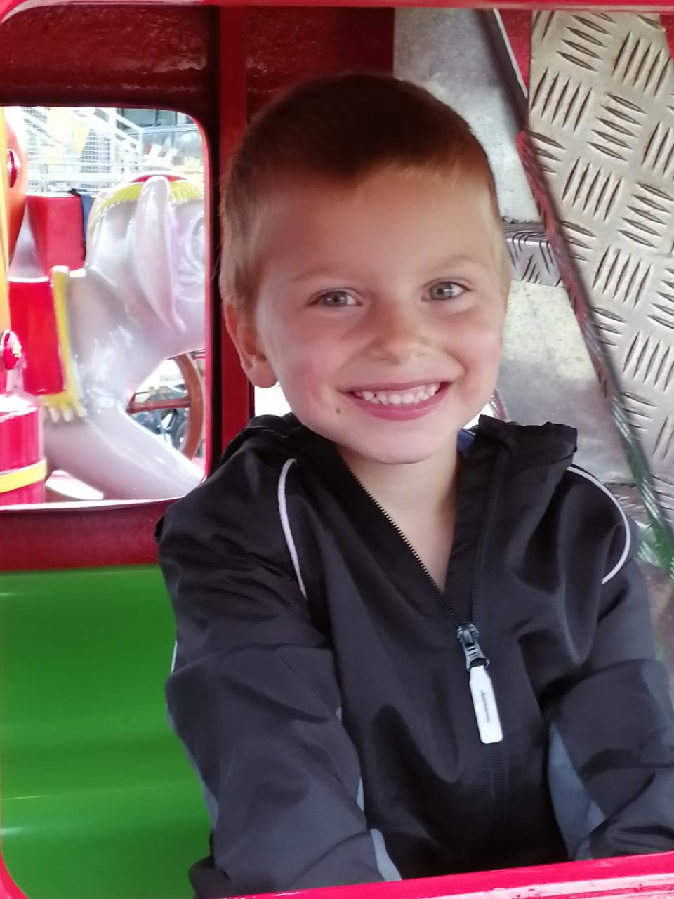 Boy in a play car