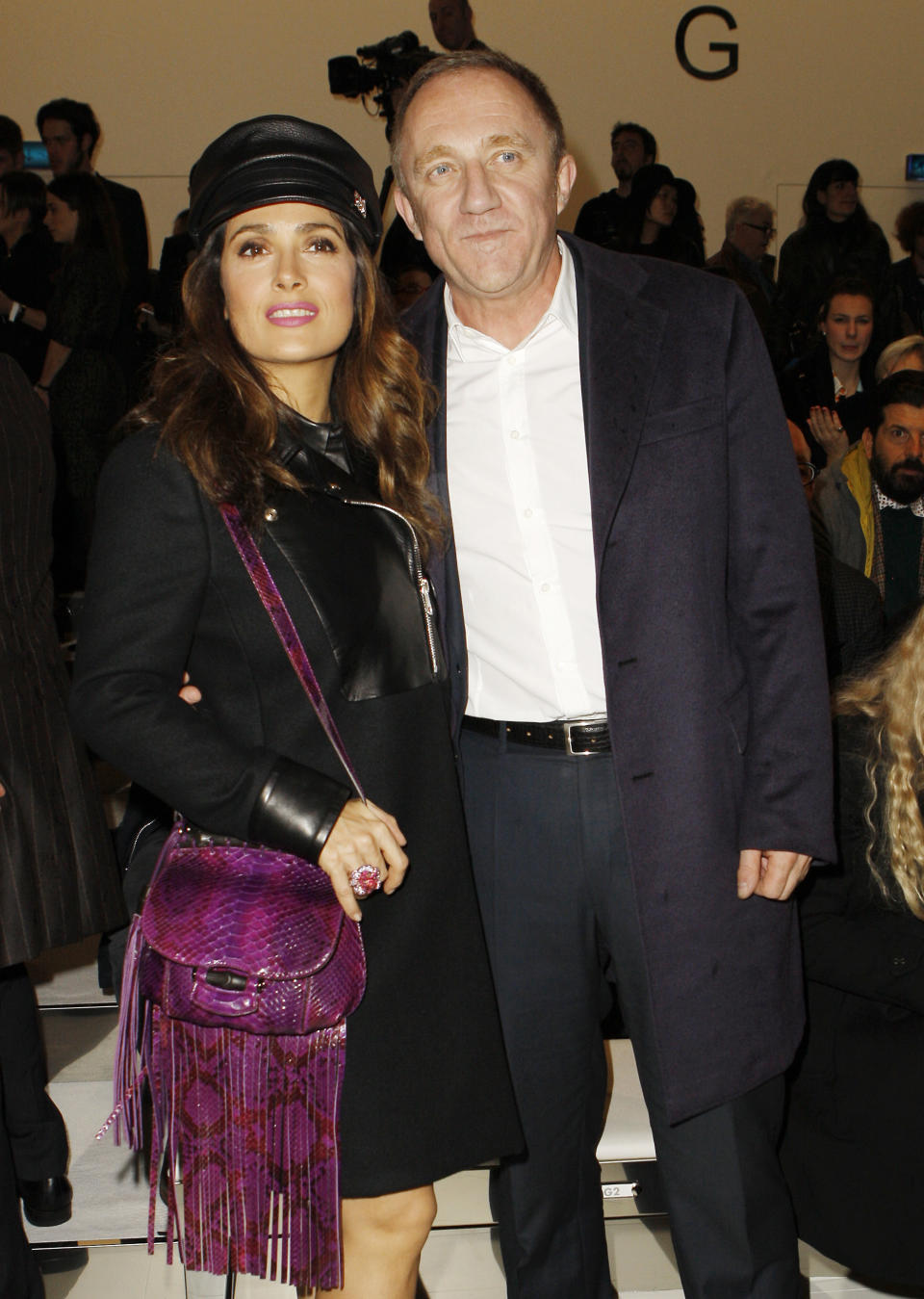 Mexican actress Salma Hayek, left, poses with her husband François-Henri Pinault, of France, prior to the start of the Gucci women's Fall-Winter 2014-15 collection, part of the Milan Fashion Week, unveiled in Milan, Italy, Wednesday, Feb. 19, 2014. (AP Photo/str)