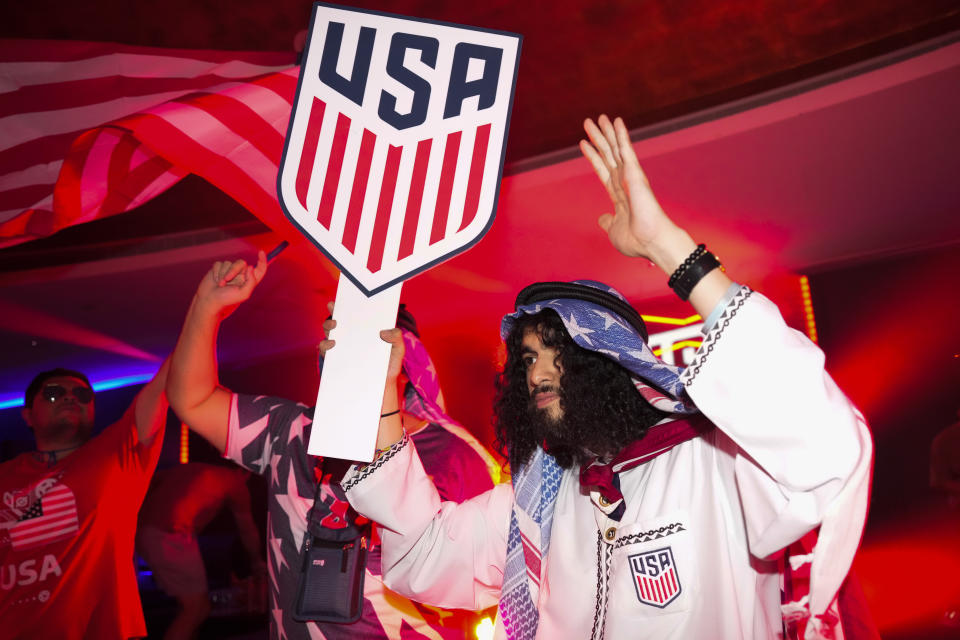 People dance during an official U.S. Soccer fan party at the Budweiser World Club ahead of a FIFA World Cup group B soccer match between the United States and Wales, in Doha, Sunday, Nov. 20, 2022. (AP Photo/Ashley Landis)