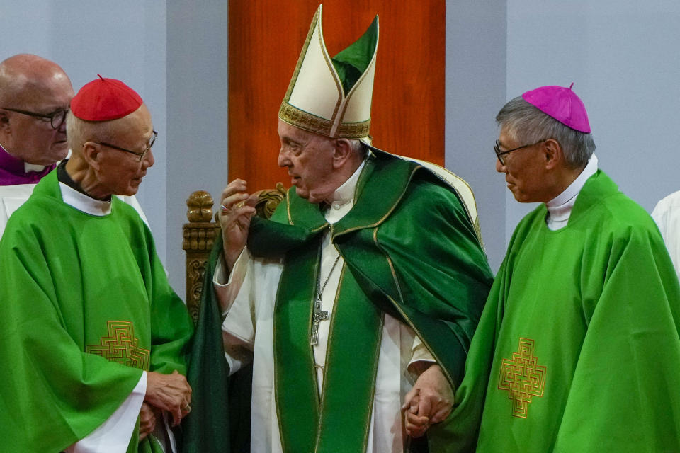 Pope Francis is joined by Cardinal John Tong Hon, left, and Cardinal-elect Stephen Chow, both from Hong Kong, after presiding over a mass at the Steppe Arena in the Mongolian capital Ulaanbaatar, Sunday, Sept. 3, 2023. Francis is in Mongolia to minister to one of the world's smallest and newest Catholic communities. Neighboring China's crackdown on religious minorities has been a constant backdrop to the trip, even as the Vatican hopes to focus attention instead on Mongolia and its 1,450 Catholics. (AP Photo/Ng Han Guan)