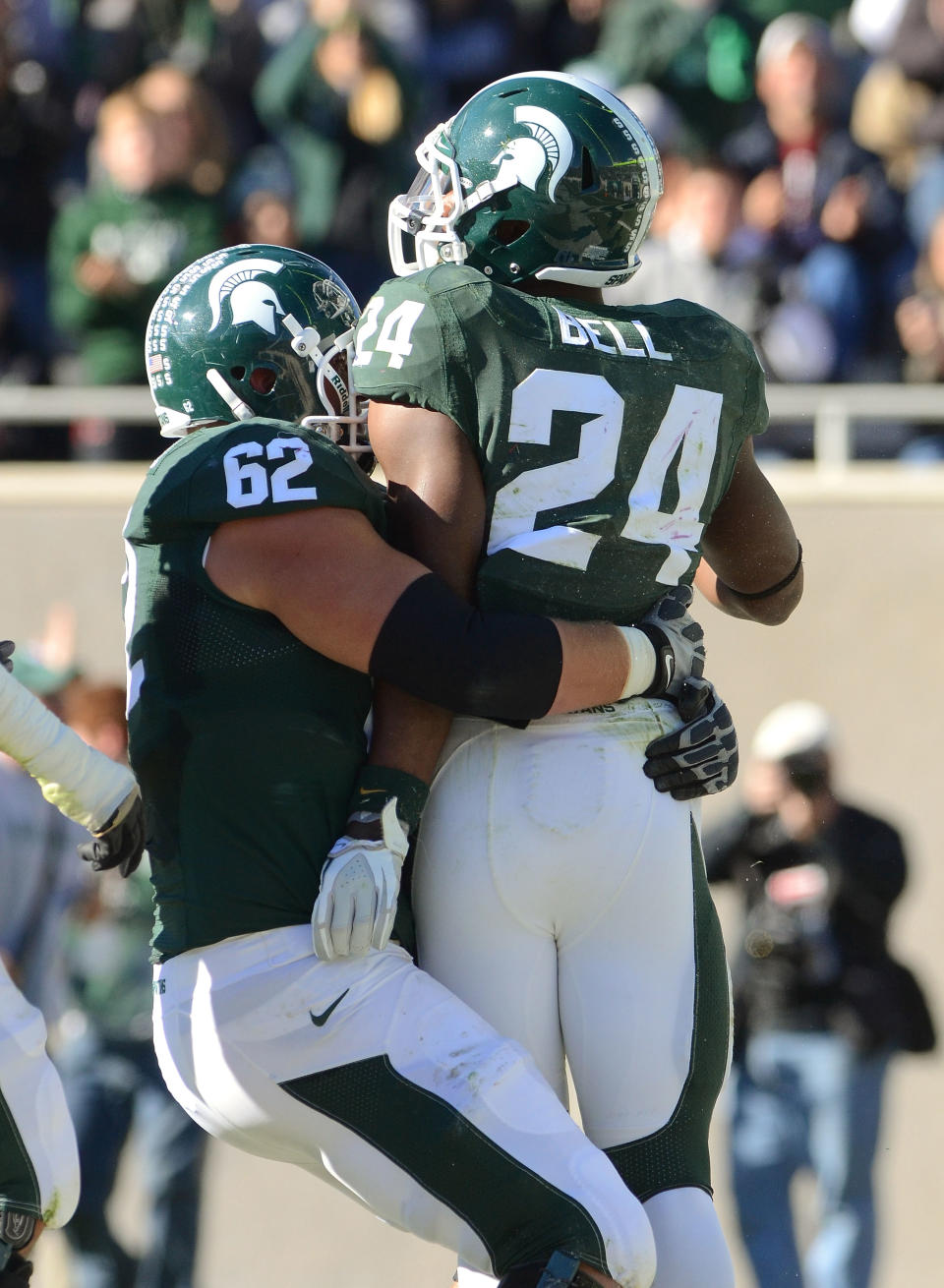 EAST LANSING, MI - NOVEMBER 05: Chris McDonald #62 of the Michigan State Spartans hugs running back Le'Veon Bell #24 after Bell scored a touchdown in the second quarter of the game against the Minnesota Golden Gophers at Spartan Stadium on November 5, 2011 in East Lansing, Michigan. (Photo by Mark A. Cunningham/Getty Images)