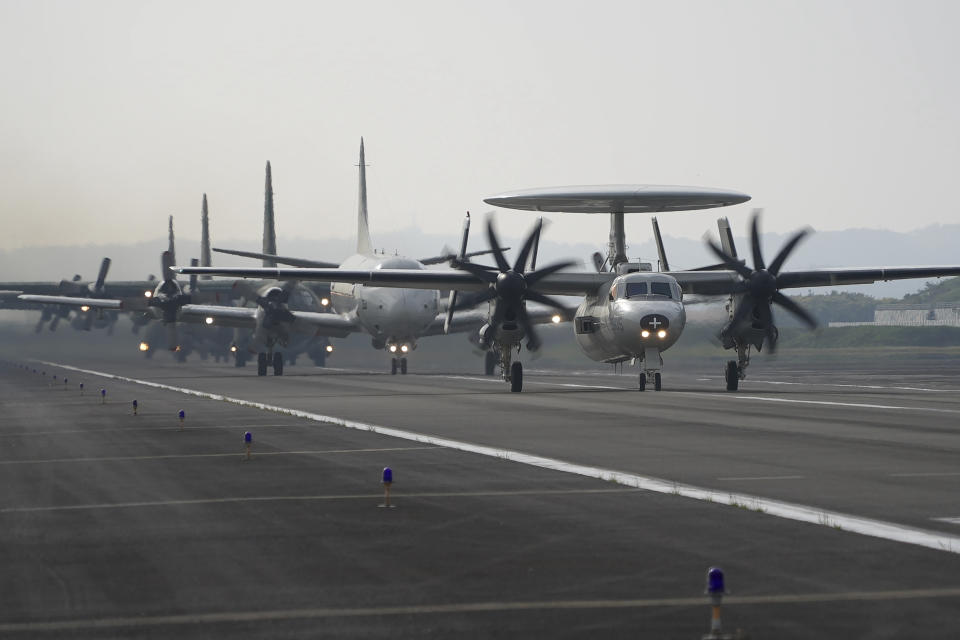 An E-2 early warning aircraft leads other aircrafts at an airbase in southern Taiwan's Pingtung county on Tuesday, Jan. 30, 2024. Taiwan is holding spring military drills following its recent presidential election and amid threats from China, which claims the island as its own territory that it is determined to annex, possibly by force.(AP Photo/Johnson Lai)