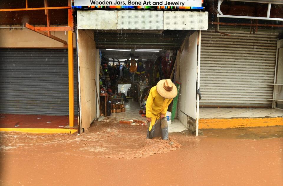 A person wades through muddy water