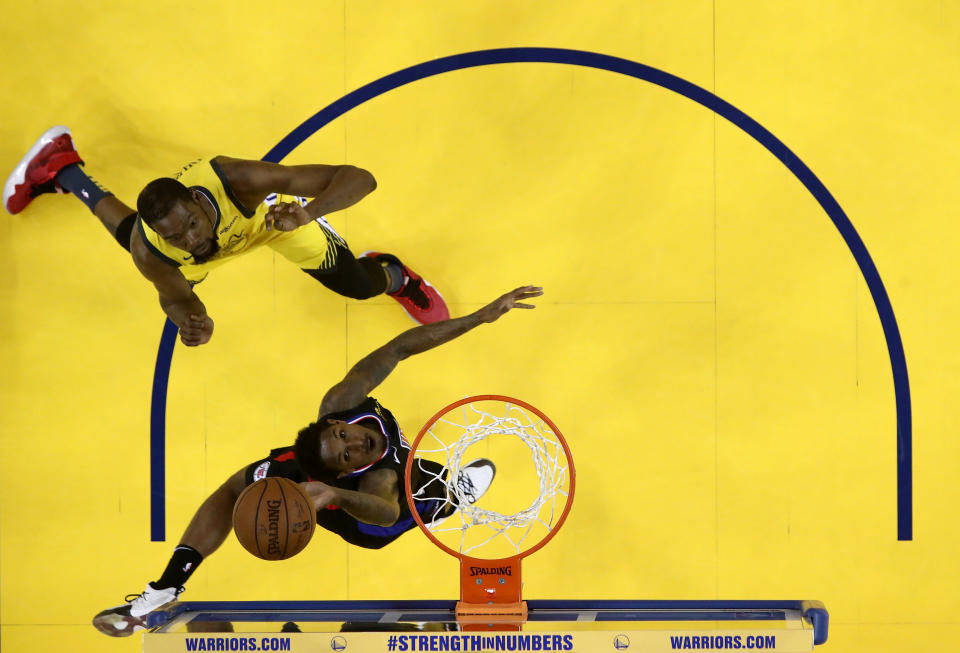 OAKLAND, CALIFORNIA - APRIL 15:  Lou Williams #23 of the LA Clippers goes up for a shot on Kevin Durant #35 of the Golden State Warriors during Game Two of the first round of the 2019 NBA Western Conference Playoffs at ORACLE Arena on April 15, 2019 in Oakland, California.  NOTE TO USER: User expressly acknowledges and agrees that, by downloading and or using this photograph, User is consenting to the terms and conditions of the Getty Images License Agreement.  (Photo by Ezra Shaw/Getty Images)