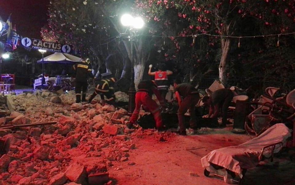  Firefighters remove debris outside of a cafe following an earthquake  - Credit: GIANNIS KIARIS/EPA