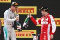 Formula One - F1 - Spanish Grand Prix 2015 - Circuit de Catalunya, Barcelona, Spain - 10/5/15 Mercedes' Nico Rosberg celebrates his win on the podium with Ferrari's Sebastian Vettel Reuters / Gustau Nacarino