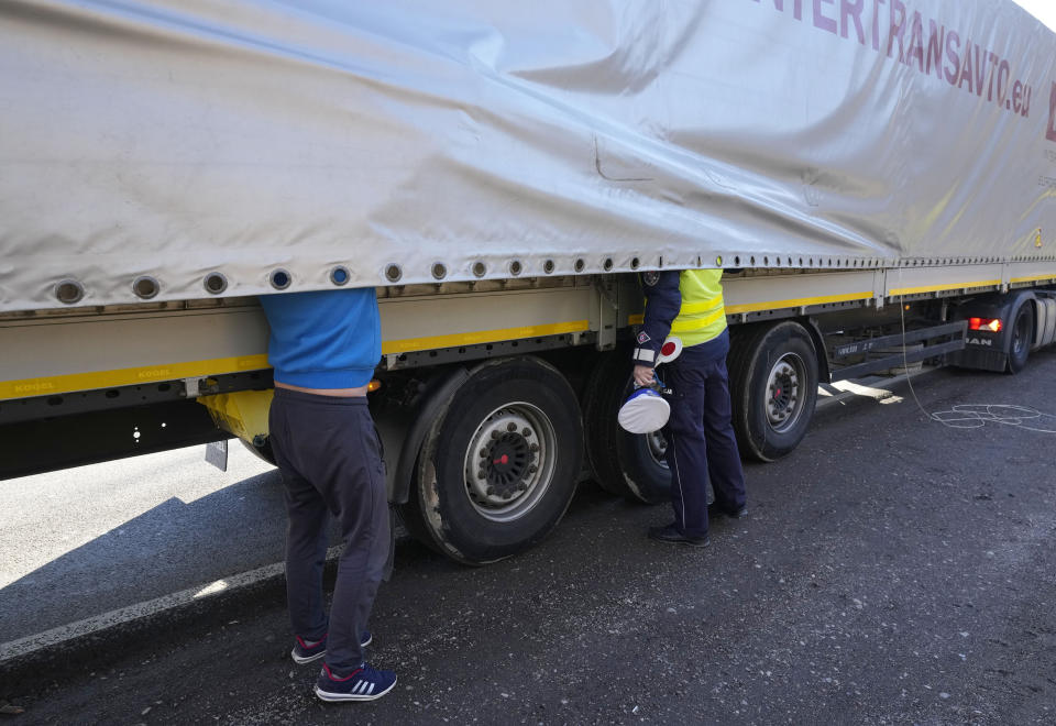 Polish police checking drivers' documents and vehicles being turned back from the Chreptowce near Kuznica, border crossing with Belarus that was closed in the morning because of a large group of migrants camping in the area on the Belarus side who had tried to illegally push their way into Poland and into the European Union, in Kuznica, Poland, on Tuesday, Nov. 9, 2021. Poland says the migrant pressure is organized by the Belarus authoritarian government to destabilize the EU in retaliation for Western sanctions. (AP Photo/Czarek Sokolowski)