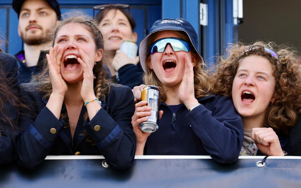 Spectators cheer on the two crews