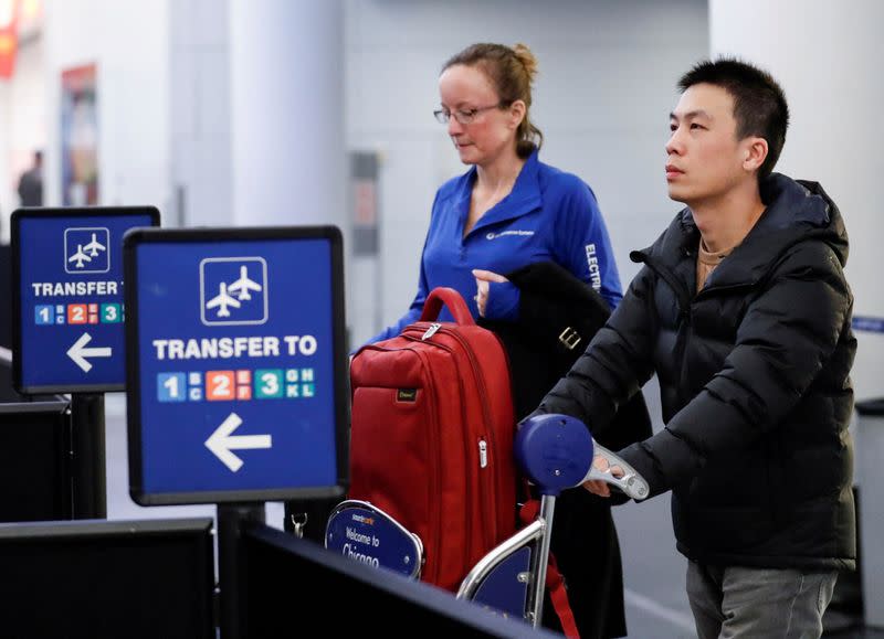 FILE PHOTO: Passengers arrive at O'Hare airport in Chicago.