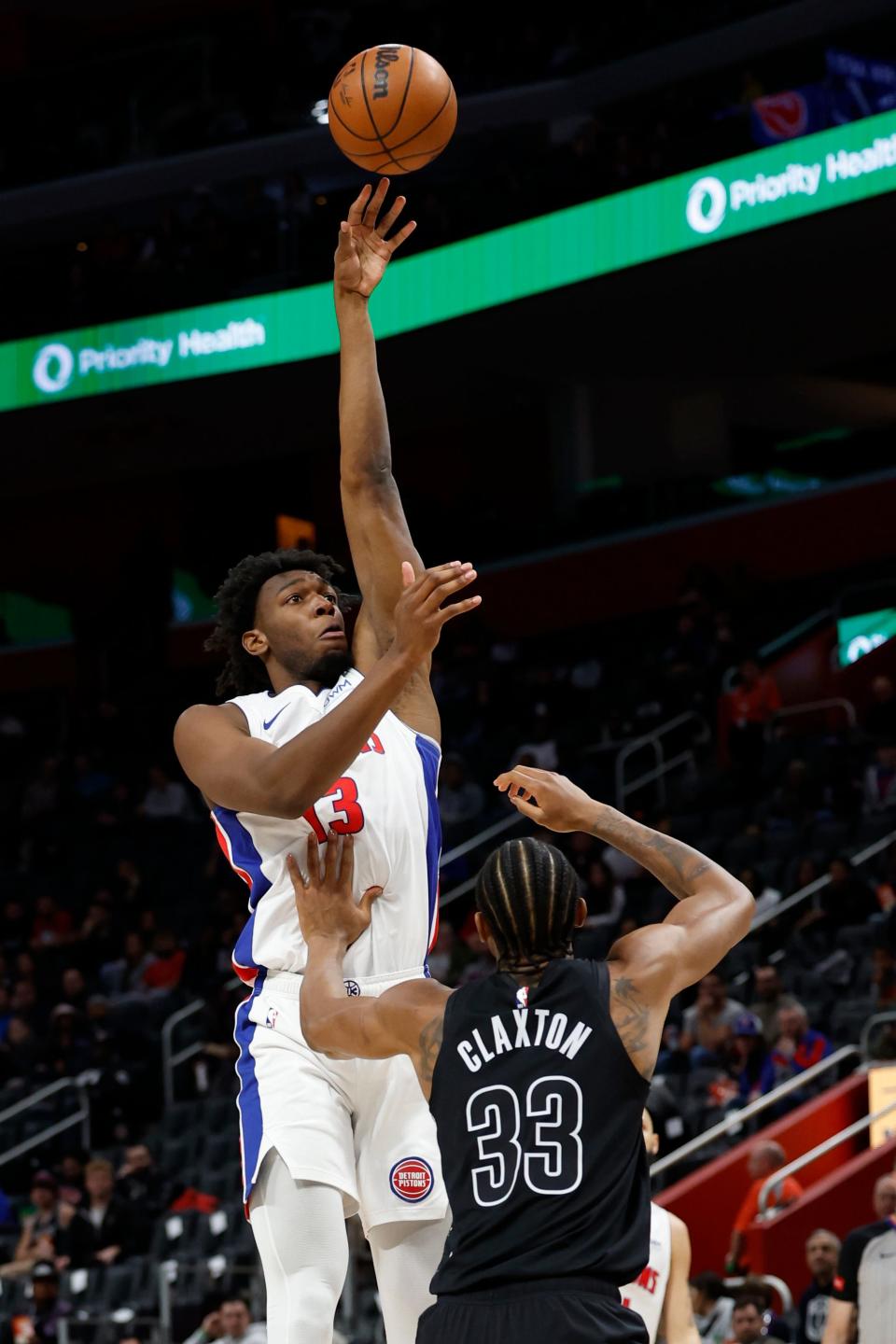 Detroit Pistons center James Wiseman (13) shoots on Brooklyn Nets center Nic Claxton (33) in the first half at Little Caesars Arena in Detroit on Thursday, March 7, 2024.