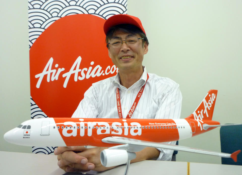 In this Sept. 28, 2012 photo, AirAsia Japan President Kazuyuki Iwakata speaks during an interview in Tokyo. “It’s not that the meals on standard fares were ever free. The charge was just part of the ticket price,” Iwakata told The Associated Press. “With us, people pay only for what they need.” As a marketing ploy, AirAsia Japan, which started operations in August, offered tickets for just 5 yen (5 cents) to the first 10,000 people. They quickly sold out. (AP Photo/Yuri Kageyama)