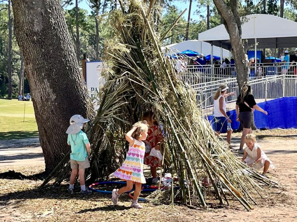 Children play in a fort contructed of bamboo at the Constellation Furyk & Friends Kids Zone.