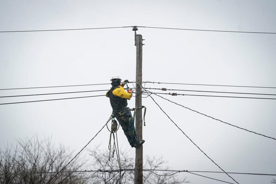 Pouring rain did not stop this DTE crew from working on downed power lines behind houses off of Thomas Avenue in Warren Monday, Feb. 27, 2023.