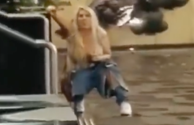 A woman squats appearing to urinate at Regimental Square in Sydney.