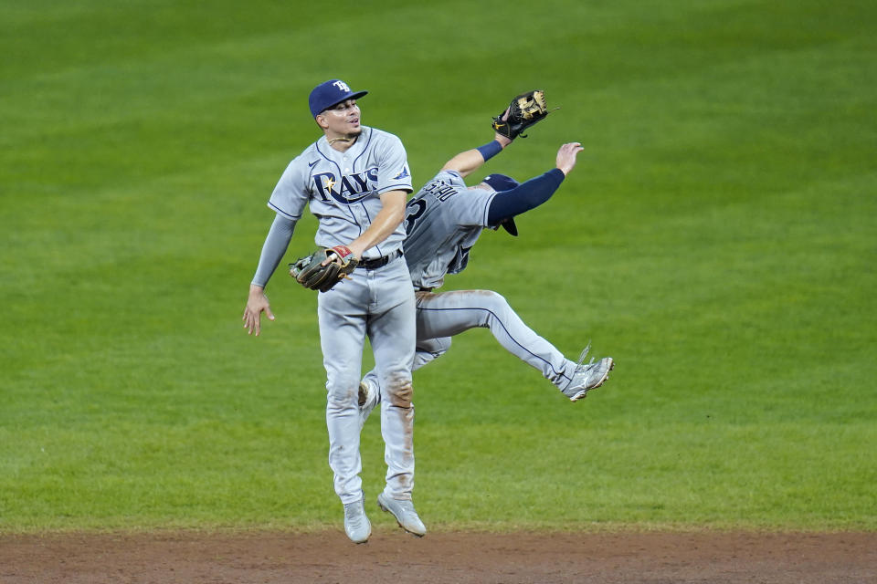 Tampa Bay Rays shortstop Willy Adames, left, and second baseman Michael Brosseau celebrate after defeating the Baltimore Orioles in the second game of a baseball doubleheader, Thursday, Sept. 17, 2020, in Baltimore. The Rays won 10-6 to clinch a playoff berth. (AP Photo/Julio Cortez)