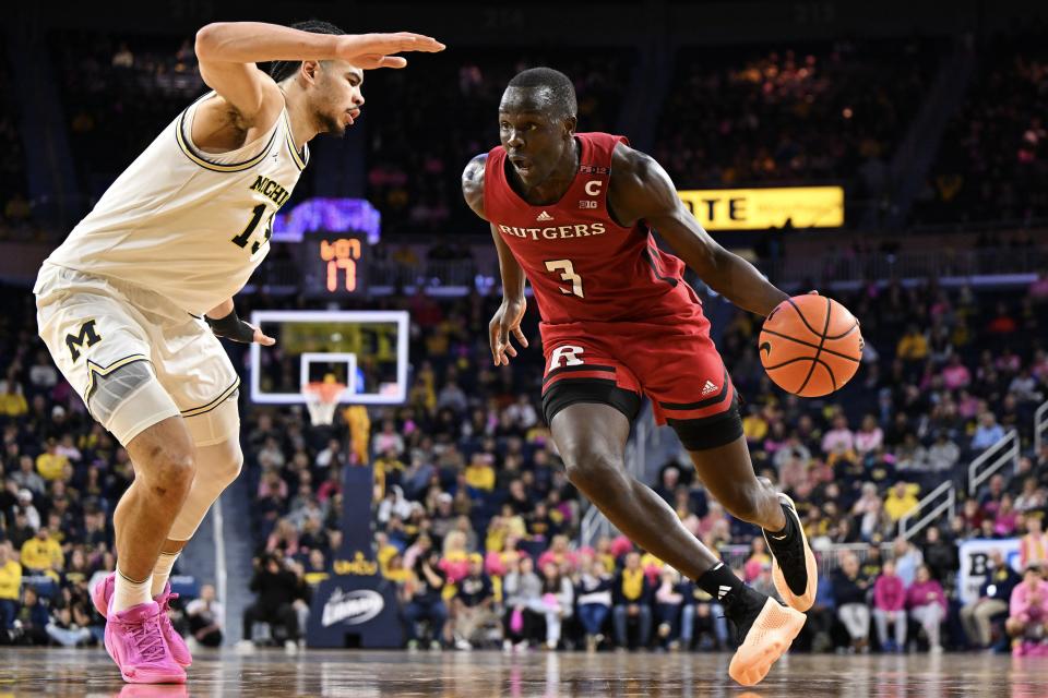 Mawot Mag of the Rutgers Scarlet Knights dribbles against Olivier Nkamhoua of the Michigan Wolverines during the second half at Crisler Center on Saturday, Feb. 3 in Ann Arbor, Michigan.