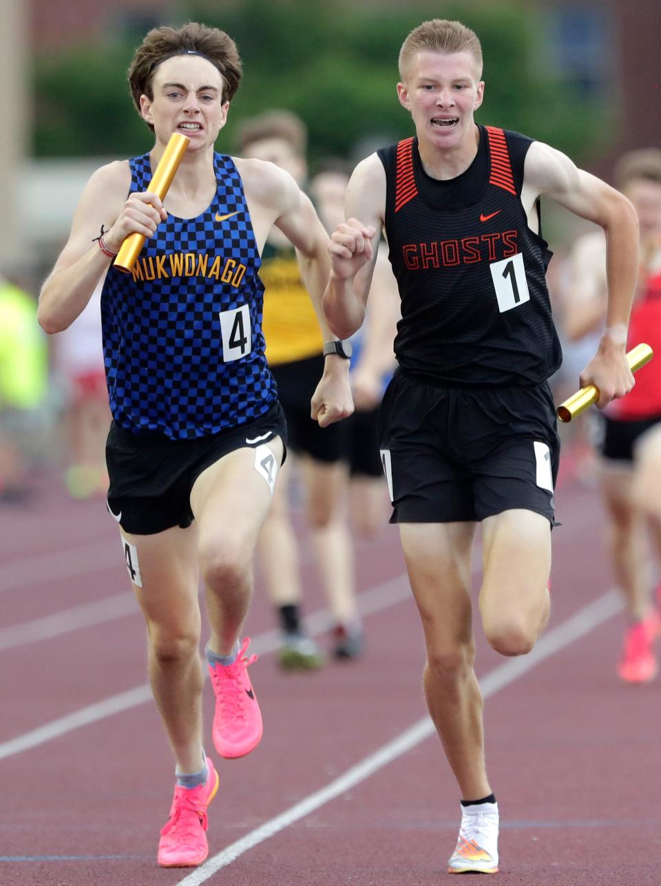Mukwonago's Joe McNulty passes Kaukauna's Aaron Schimke in the final stretch during Friday's Division 1 3,200 relay at Veterans Memorial Stadium in La Crosse. Kaukauna finished seventh in the race with a time of 7 minutes, 58.99 seconds.