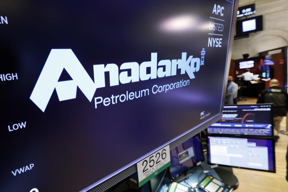 FILE - In this April 12, 2019, file photo the logo for Anadarko Petroleum Corp. appears above a trading post on the floor of the New York Stock Exchange.  Warren Buffet’s Berkshire Hathaway is financing a bid by Occidental Petroleum for Anadarko, potentially upending Chevron’s $33 billion offer for the energy company. Anadarko and Chevron signed a merger agreement earlier this month, but Anadarko Petroleum said Monday, April 29, that it is now considering an offer from Occidental worth about $57 billion in cash and stock. (AP Photo/Richard Drew, File)