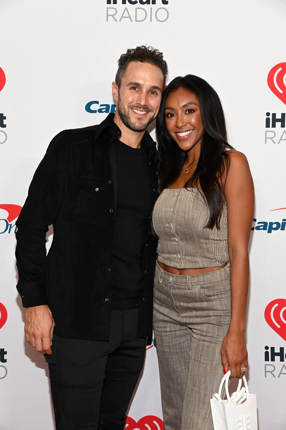 Zac Clark and Tayshia Adams attend the 2021 iHeartRadio Music Festival on September 17, 2021 at T-Mobile Arena in Las Vegas, Nevada.
