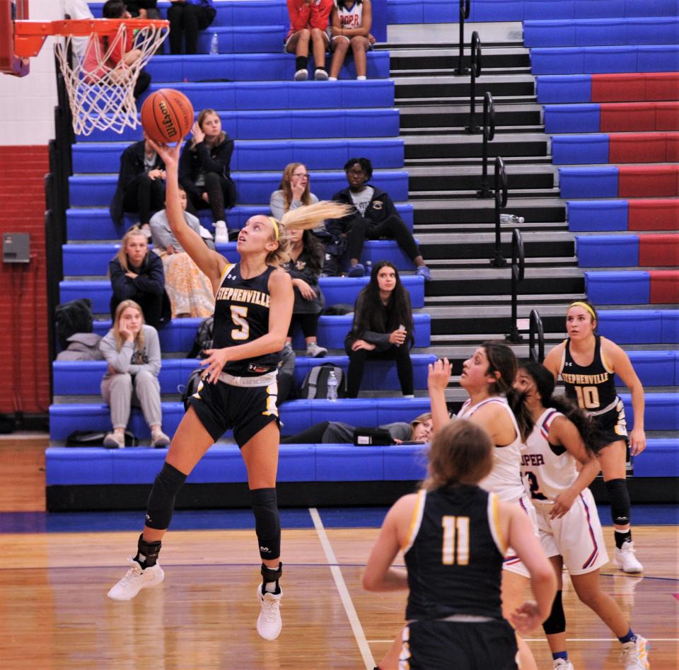 Stephenville's Landri Withers (5) drives to the basket against the Cooper defense to give the Honeybees a 45-42 lead with 4:26 left in the game.