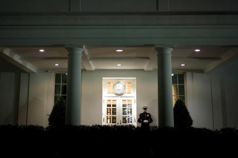 A Marine stands outside the West Wing of the White House 