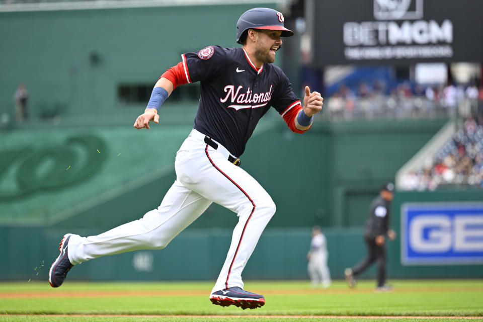 Washington Nationals' Lane Thomas heads home on a two-run single by Nationals' Luis García Jr. during the first inning of a baseball game against the Houston Astros at Nationals Park, Sunday, April 21, 2024, in Washington. (AP Photo/John McDonnell)