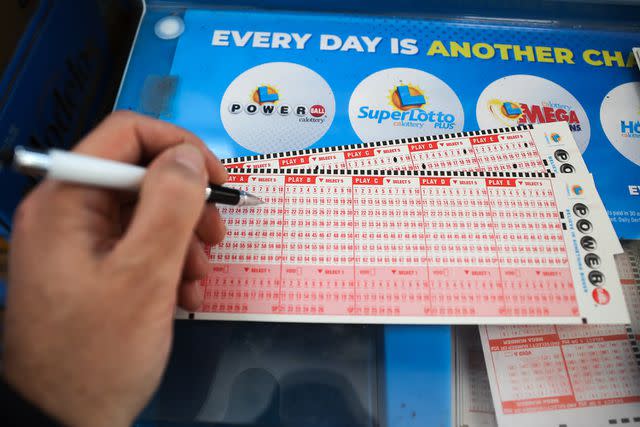 <p>Tayfun Coskun/Anadolu Agency via Getty</p> Stock image of a person playing Powerball lottery