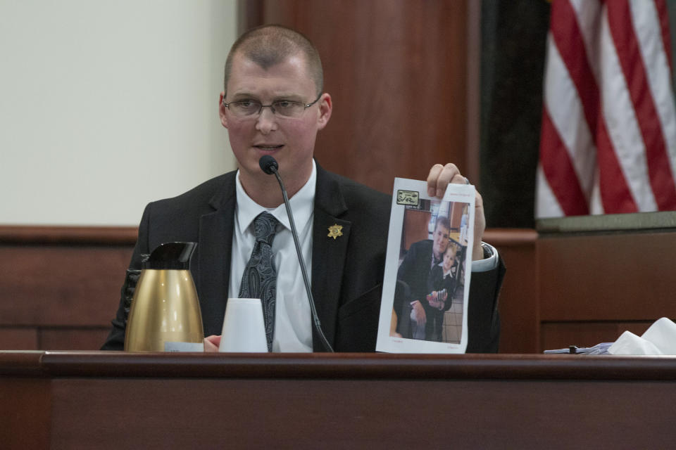 Lexington County Sheriff's Department Sgt. Adam Creech shows a photograph of one of the Jones children to the jury during the trial of Timothy Jones Jr. in Lexington, S.C., Wednesday, May 22, 2019. Lawyers defending Jones turned Wednesday to brain science in an effort to spare their client from the death penalty. (Tracy Glantz/The State via AP, Pool)