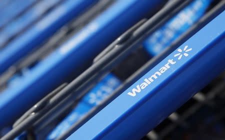 Shopping carts are seen outside a new Wal-Mart Express store in Chicago July 26, 2011. REUTERS/John Gress/Files