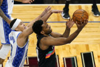 San Antonio Spurs forward Keita Bates-Diop, right, makes a shot as he gets past Orlando Magic guard R.J. Hampton during the second half of an NBA basketball game, Monday, April 12, 2021, in Orlando, Fla. (AP Photo/John Raoux)