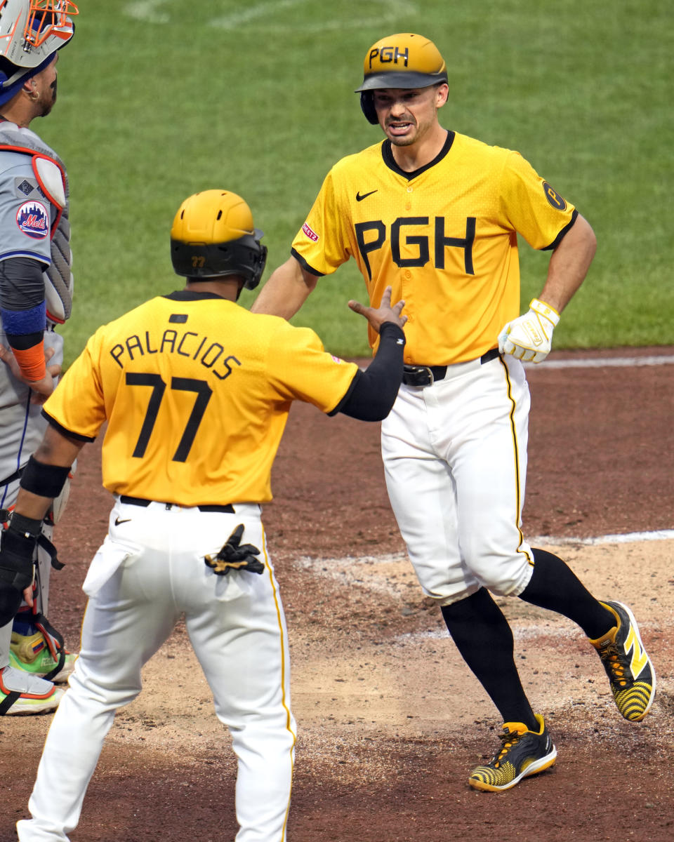 Pittsburgh Pirates' Bryan Reynolds, right, is greeted by Joshua Palacios (77) after hitting a two-run home run off New York Mets starting pitcher Luis Severino during the fifth inning of a baseball game in Pittsburgh, Friday, July 5, 2024. (AP Photo/Gene J. Puskar)