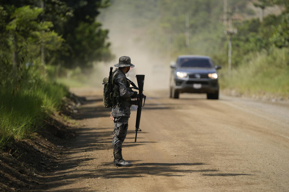 A soldier stands guard in El Estor, in the northern coastal province of Izabal, Guatemala, Monday, Oct. 25, 2021. The Guatemalan government has declared a month-long, dawn-to-dusk curfew and banned pubic gatherings following protests against a nickel mining project. (AP Photo/Moises Castillo)