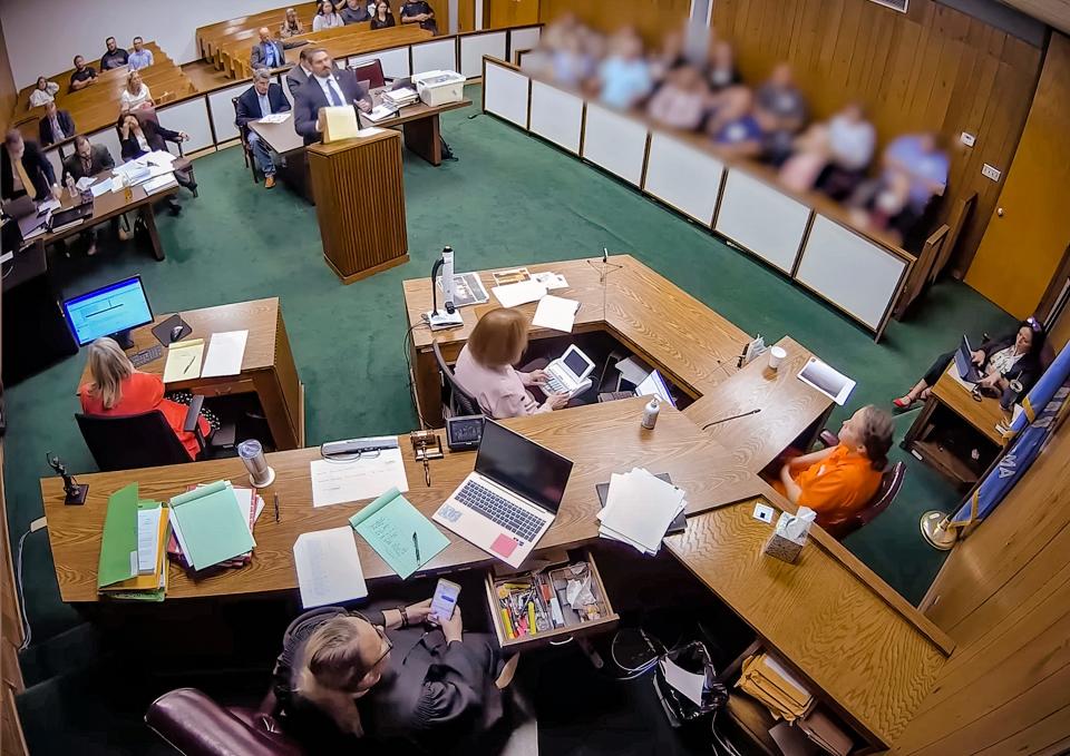 In this screenshot from a security camera recording, Lincoln County District Judge Traci Soderstrom looks at her cellphone during a murder trial in June. Faces of the jurors have been blurred to protect their identities.