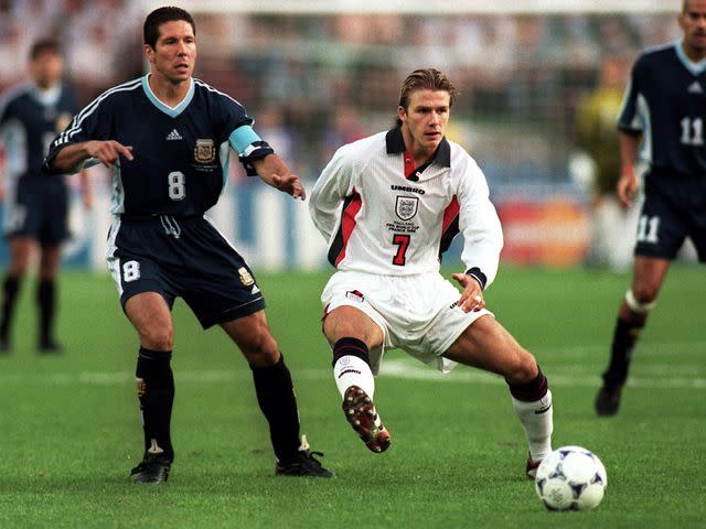 <p>Tony Marshall/EMPICS/Getty</p> David Beckham battles with Diego Simeone for the ball during the 1998 FIFA World Cup.