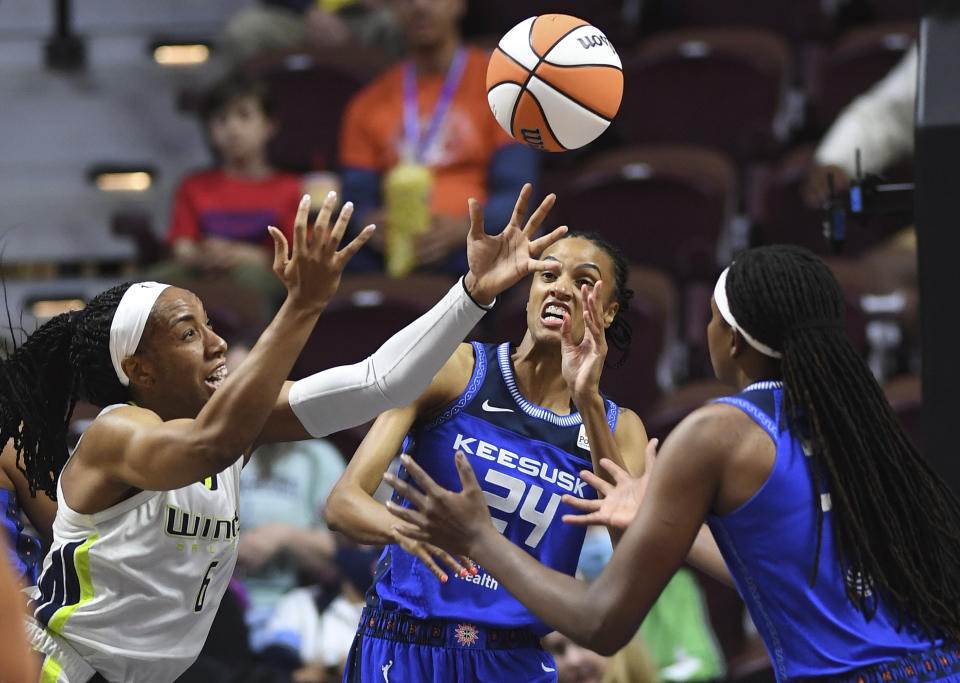 Connecticut Sun forward DeWanna Bonner (24) and forward Jonquel Jones, right, compete against Dallas Wings forward Kayla Thornton (6) for a rebound during a WNBA basketball game Tuesday, May 24, 2022, in Uncasville, Conn. (Sean D. Elliot/The Day via AP)